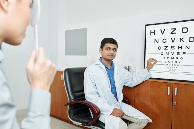 Optometrist working with patient