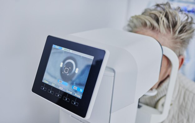 Optometry machine and woman with vision test eye correction and retina consultation Healthcare ophthalmology and patient having a scan on eyes with a monitor for optical examination and eyesight