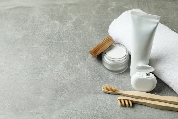 Oral care accessories on gray textured background