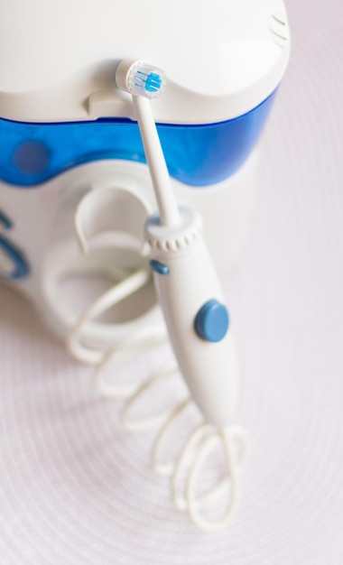 Oral hygiene Irrigator for cleaning teeth on a white background