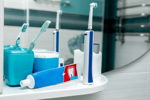 Oral hygiene kit on a white shelf.