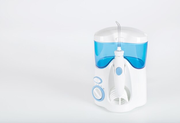 Oral irrigator on a gray background. Closeup