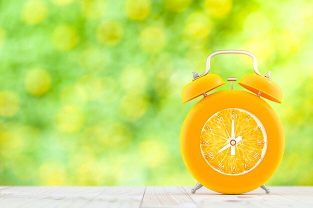 Orange alarm clock on wooden table