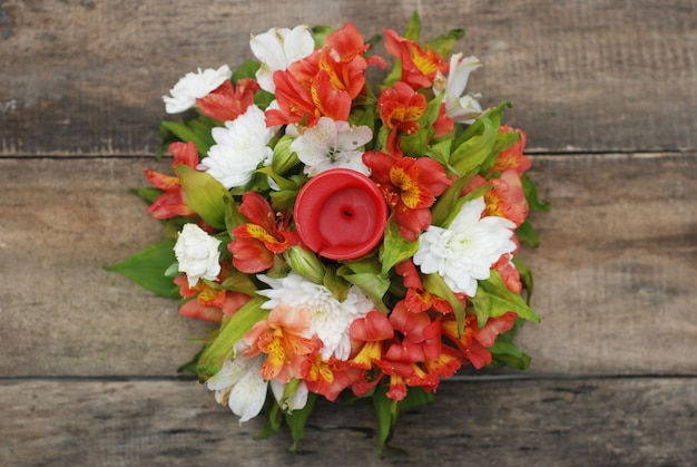 Orange alstromeria flower arrangement over wooden.