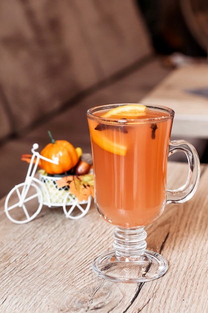 Orange autumn drink with spices in the cafe.