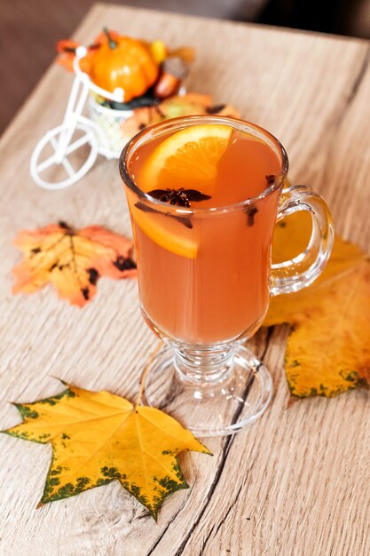 Orange autumn drink with spices in the cafe.