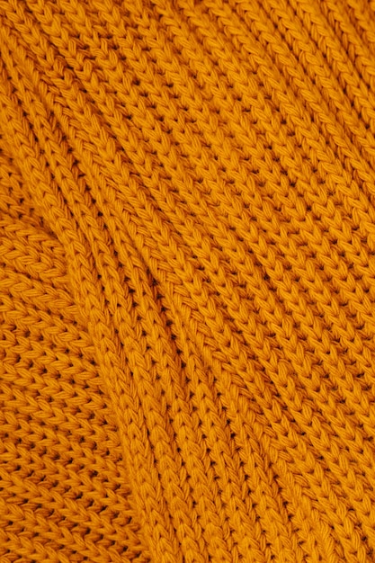 Photo orange autumn knitting wool texture background.