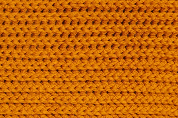 Orange autumn knitting wool texture background.