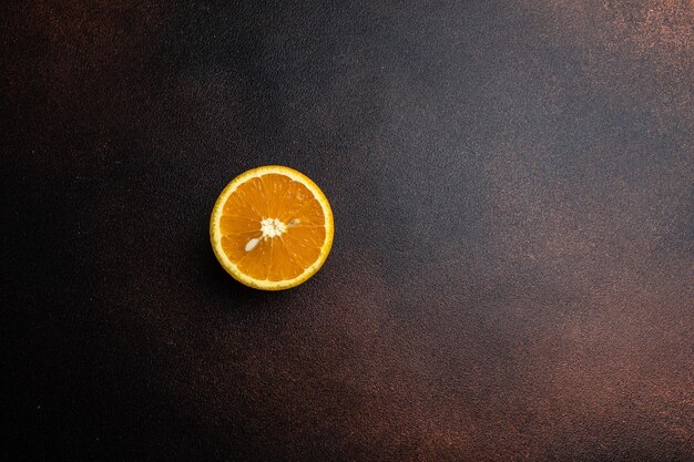 An orange on a brown background with a white center.