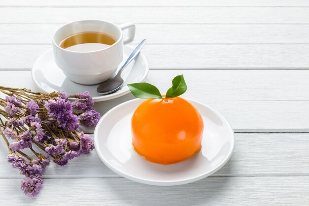 Orange cake on white wooden table