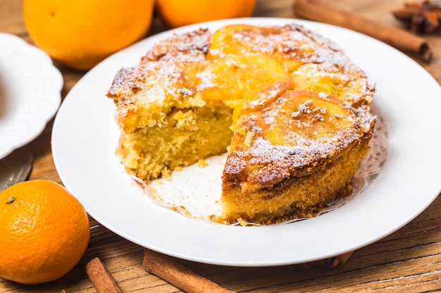 Orange cake on the wooden background