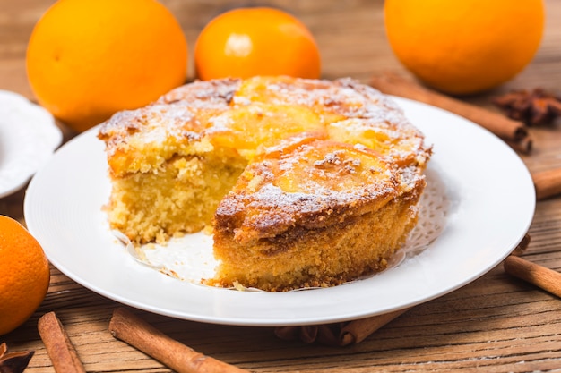 Orange cake on the wooden background