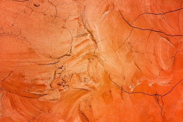 オレンジ色のセメント壁の背景とテクスチャ