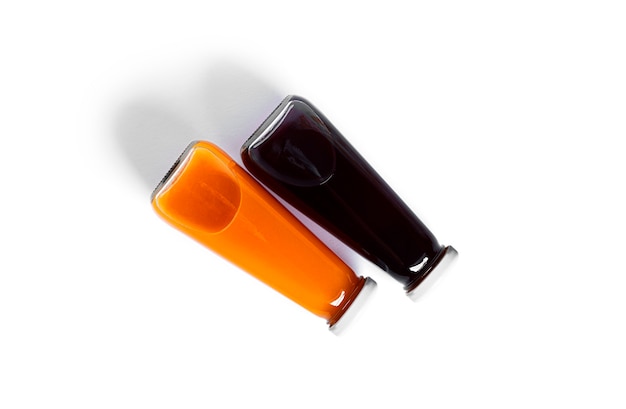 Orange and cherry juice in bottle isolated on a white background. High quality photo