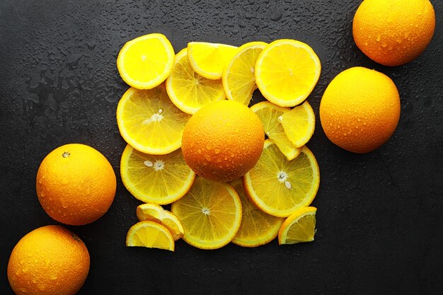 Orange citrus fruit on a stone table. Orange background.