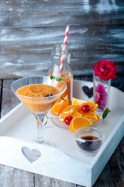 Orange cocktail with ice in a glass