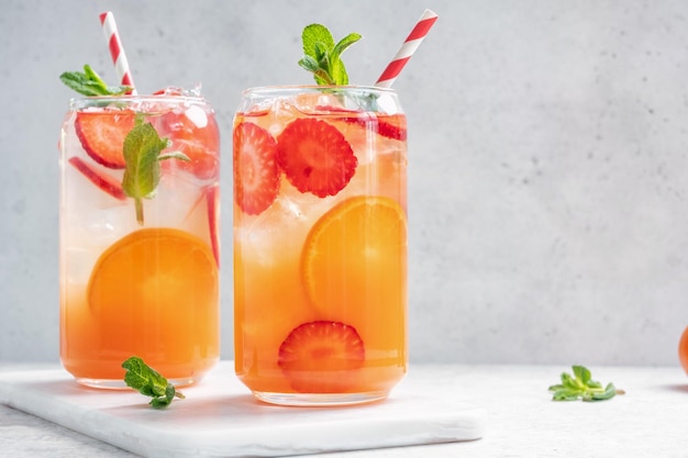 Orange cocktail with strawberries summer drink