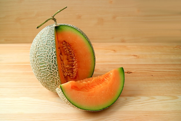 Orange Color Fresh Ripe Muskmelon with a Slice from Whole Fruit