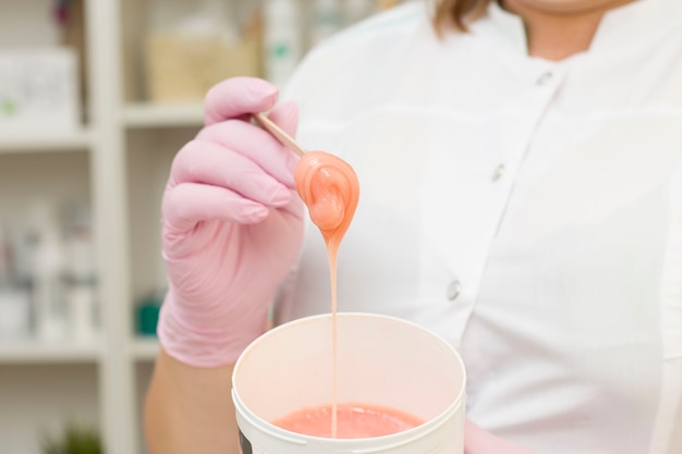 Orange, coral-colored sugaring paste