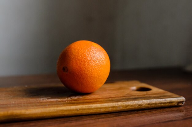 Orange on cutting board