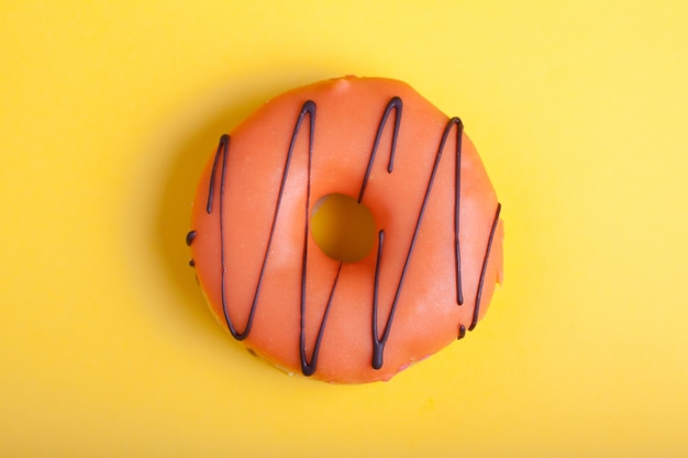 Orange donut with icing.