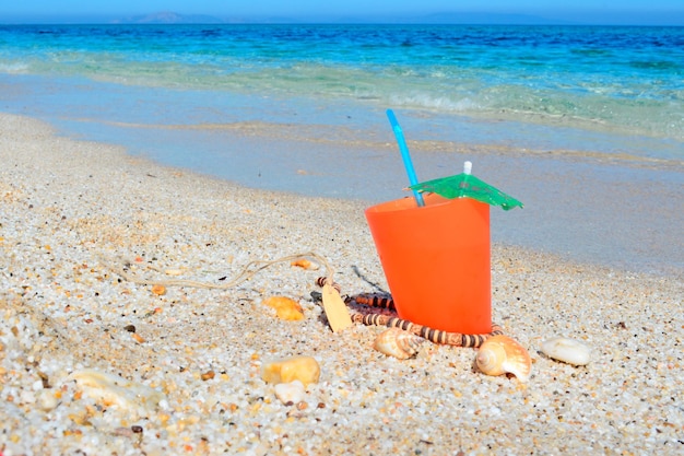 Orange drink by the shore