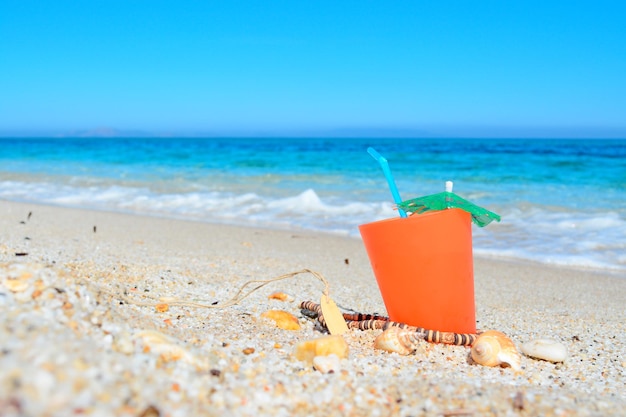 Orange drink by the shore