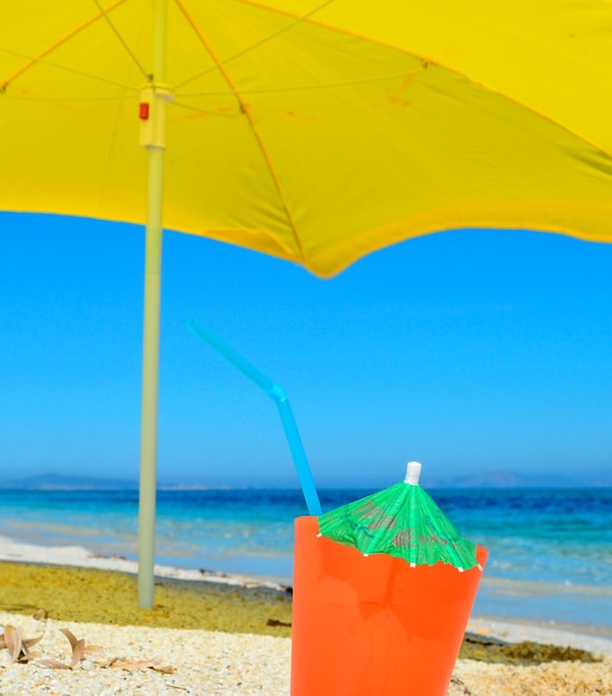 Orange drink under a yellow parasol