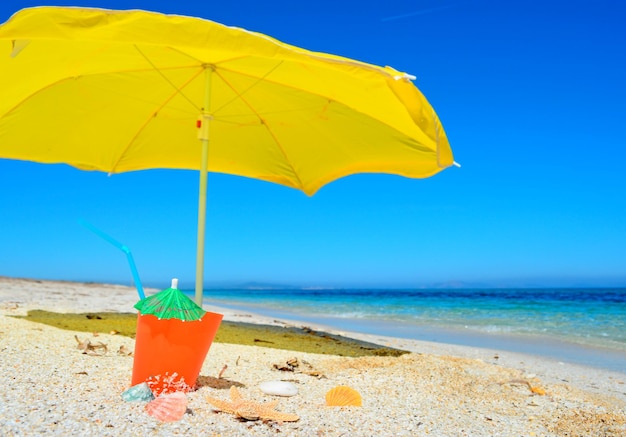 Orange drink under a yellow parasol