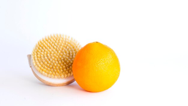 Orange and dry massage brush on white background