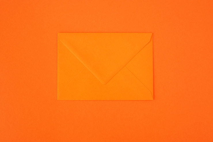 Orange envelope on orange background