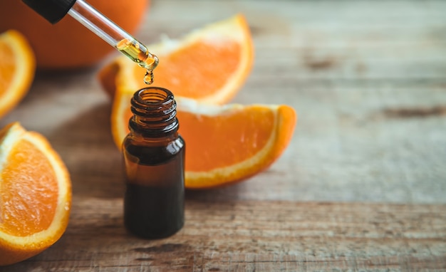 Orange essential oil in a small bottle. Selective focus. Food.