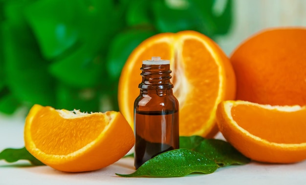 Orange essential oil in a small bottle Selective focus