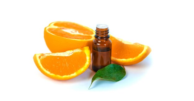 Orange essential oil in a small bottle Selective focus