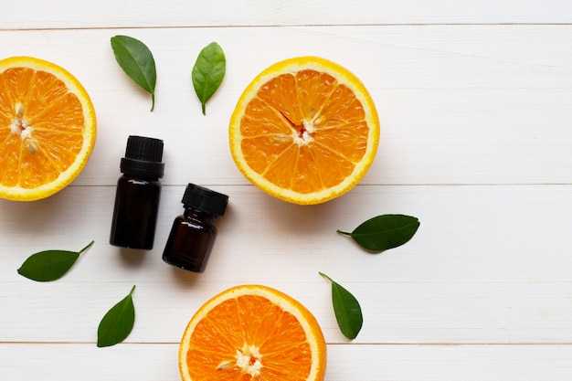 Orange essential oil with fresh orange citrus fruit