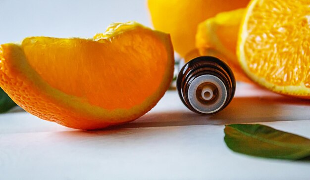Orange essential oil on a yellow background Selective focus