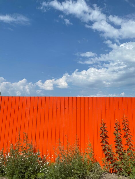 Orange fence against the blue sky