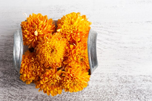 Orange flowers in box on rustic table