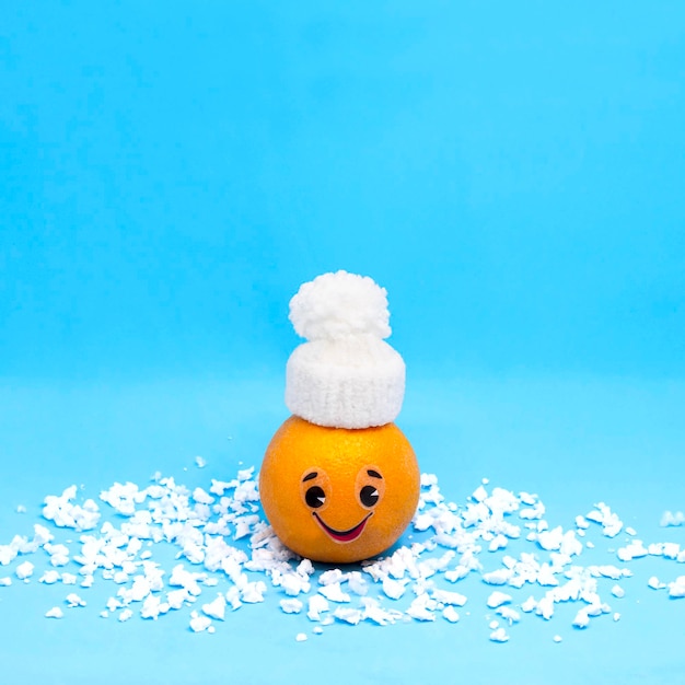 Orange in form of funny little man in winter