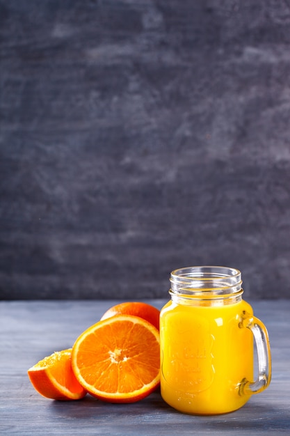 Orange fresh juice on concrete background