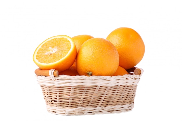 Orange fruit in basket on a white background