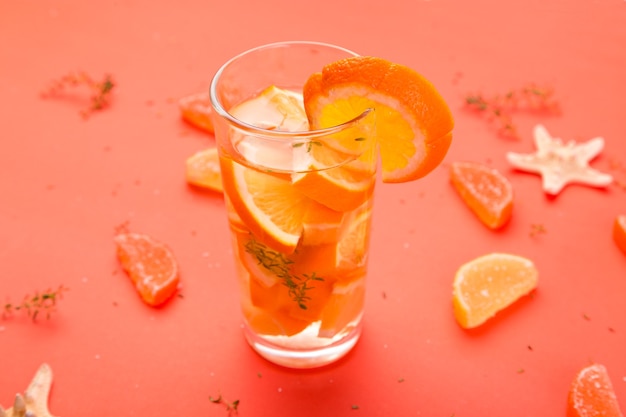 Orange fruit cocktail, detox water on orange background