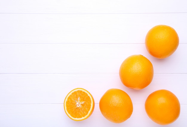 Orange fruit on a white wooden background