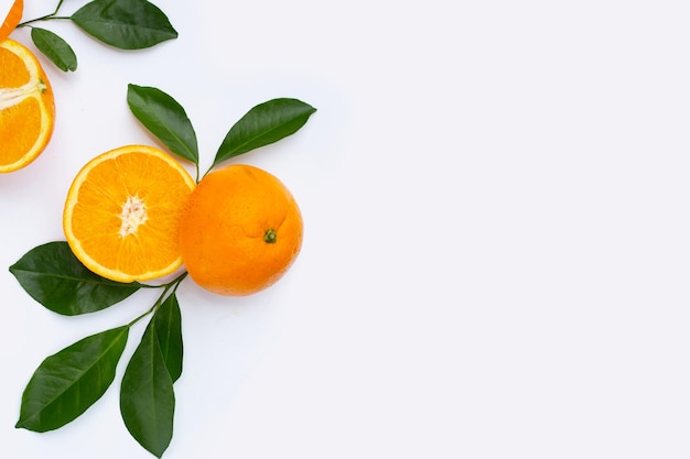 Orange fruit with green leaves on white background