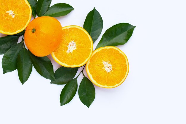 Orange fruit with green leaves on white background