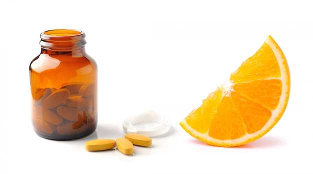 Orange fruit with vitamin c tablet and  bottle isolated on the white 