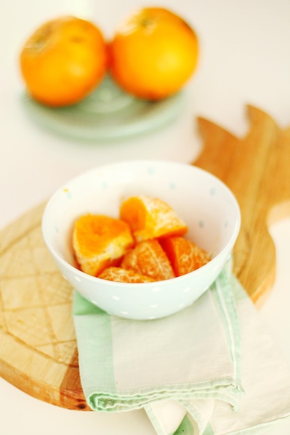 Orange fruits in bowl on table