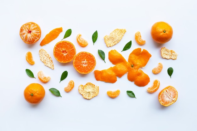 Orange fruits and green leaves on a white background. 