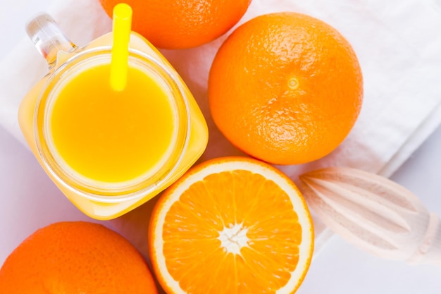Orange fruits and juice on white background citrus fruit for making juice with manual juicer