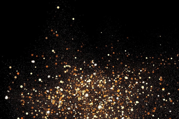 Photo orange and gold glitters on a black background